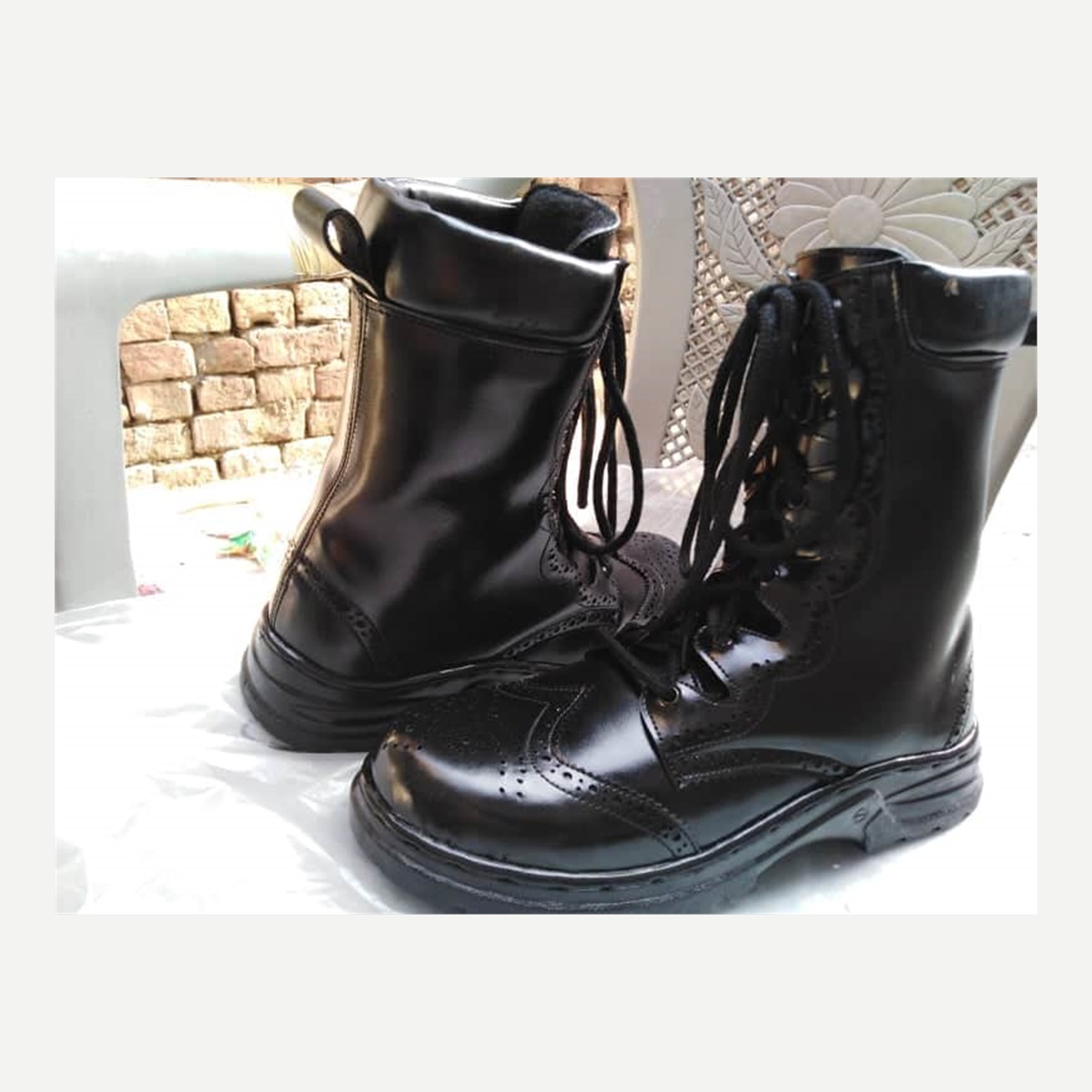 Black leather lace-up boots, side view - footwear photo reference